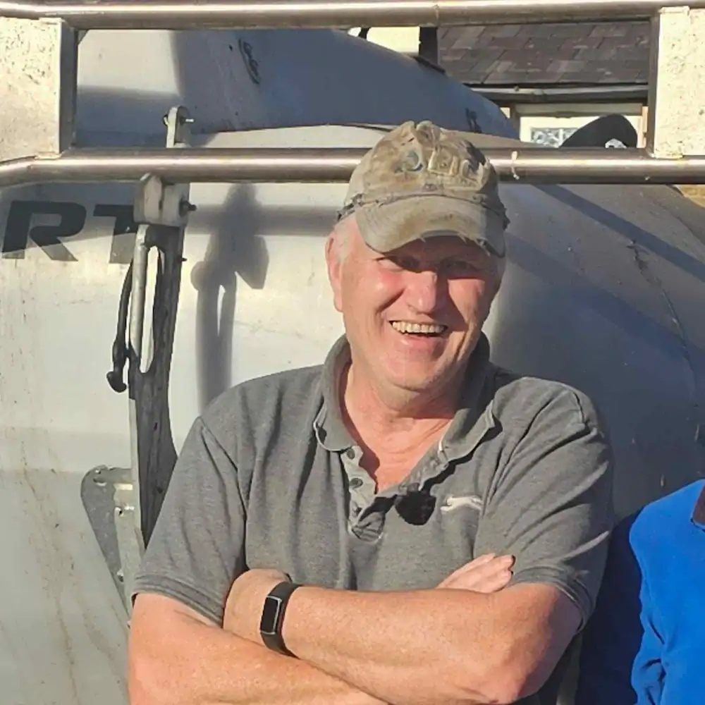 David Williams standing beside his Tow and Fert machine on his farm in North East Wales