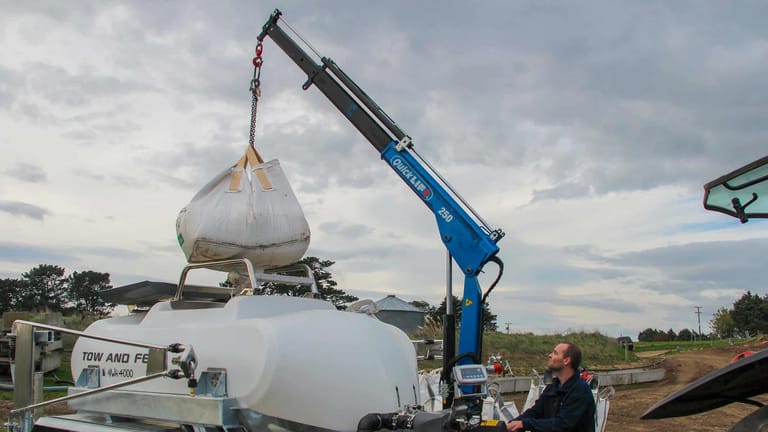 Tow and Fert Multi 4000 sprayer being loaded with fertiliser from a large bulk bag suspended by a crane.