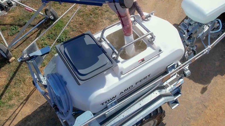 Top view of the Tow and Fert MultiCrop 4000 being filled with fertiliser through its open filling hatch.