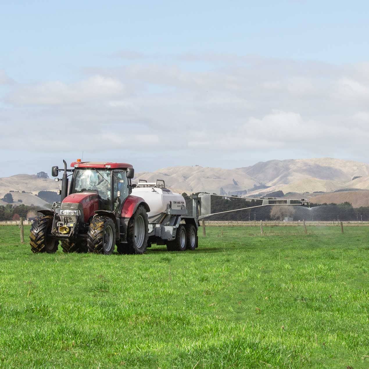 Image of tractor towing a tow and fert sprayer